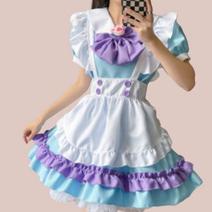 A front view of The Lucy Lou, its a frilly layered blue pinafore style sissy dress. You can see the under dress with peter pan collar, detachable paw print brooch and bow, pinafore style apron and white frilled head band.