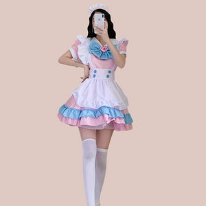 A front view of The Lucy Lou, its a frilly layered pink pinafore style sissy dress. You can see the under dress with peter pan collar, detachable paw print brooch and bow, pinafore style apron and white frilled head band.