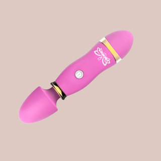 The mini cordless massager is shown here in pink.