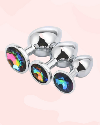 Three metallic anal plugs in small, medium and large, with multi-colour gem stones