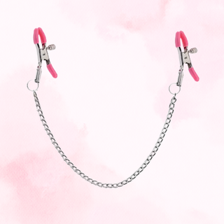 The pink tipped nipple clamps shown on a pink background