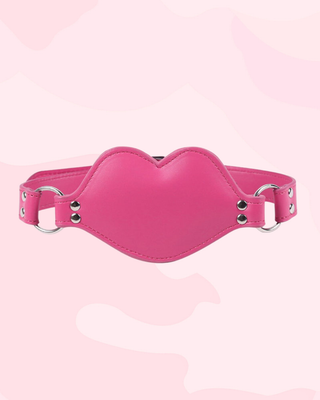 The pink PVC gag shown with the strap fixed in place.