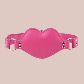 The pink PVC gag shown with the strap fixed in place.
