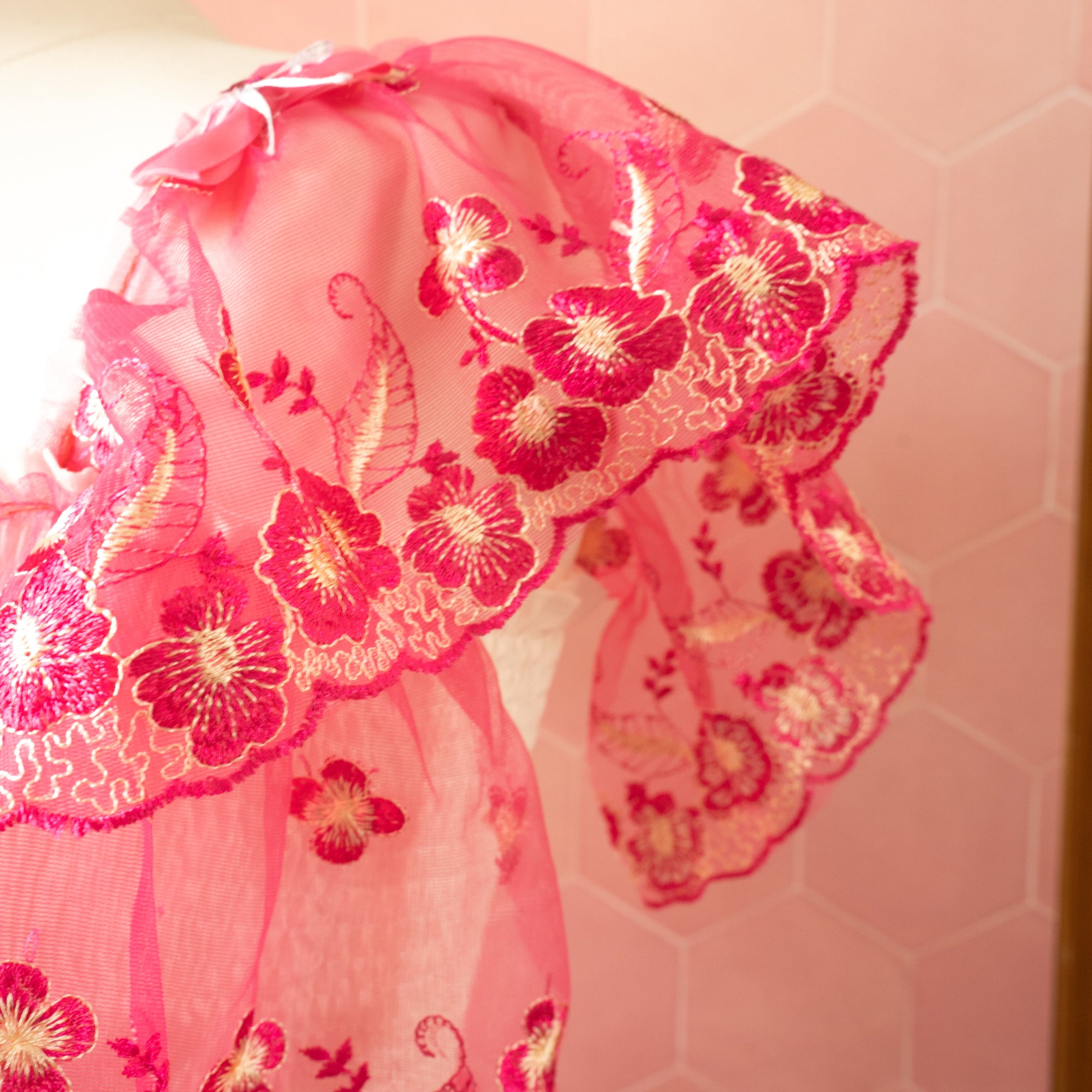 A close up of the draped sleeve with bow detailing.