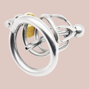 A close up underside view of the Prison Bird Small Chastity Cage, you can see the length of the cage with the singular ring between the base ring and head , the chaste bird style head with metal urethral tube attached and the integral lock in place.