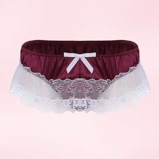Maroon satin underwear with lace and a white bow on a pink background