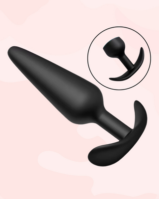 Black silicone butt plug on a pink background with an inset showing a close-up of the tapered base