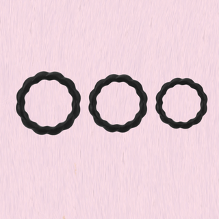 showing the three different cock ring sizes on a pink background.