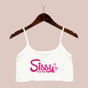 The white crop top camisole from House Of Chastity, shown on a hanger, you can see bold pink Sissy xoxo lettering.