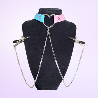 The choker being modelled on a necklace stand with the draped chains falling from the hear  and the nipple clamps fixed to the sides