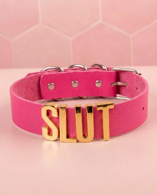 The cerise collar with gold Slut lettering shown on a soft pink background