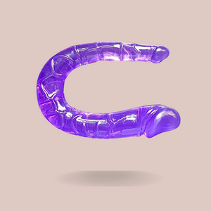 Showing the Small Purple Jelly Double Ended Dildo from House Of Chastity, you can see the two ends that differ in size, it has a lovely purple tone whilst being see-through.