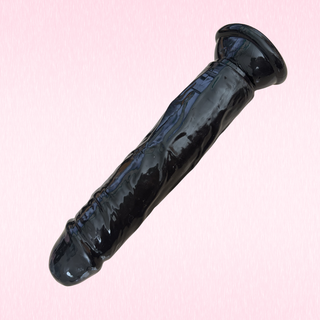 The soft jelly dildo in black on a pink background