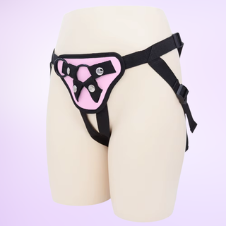 A side view of the strap on harness, it is shown on a purple background