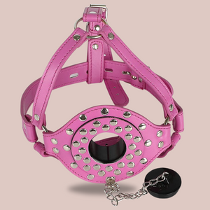 the pink faux leather studded head gag is shown here with the funnel removed, you can see the plug that can be placed in the funnel hole.