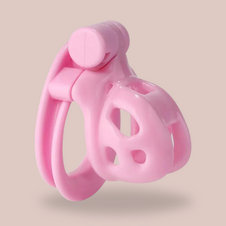 A side view of the pink Super Mini Cobra Double Cuff chastity cage.