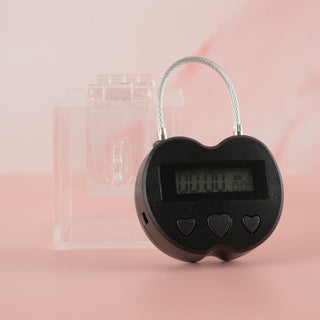 Showing the clear chastity key safe box, where you can see your chastity cage keys locked away nice and tight and you can't get to them. Also shown is the electronic lock that can be set on a timer for release.