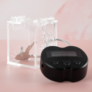 Showing the clear chastity key safe box, where you can see your chastity cage keys locked away nice and tight and you can't get to them. Also shown is the electronic lock that can be set on a timer for release.