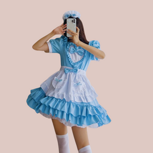 An alternate full length view of The Florence Dress, you can see the blue dress, with  frilled skirt, heart motif to the bodice and removable apron.