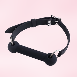 An angled view of the gag on a pink background