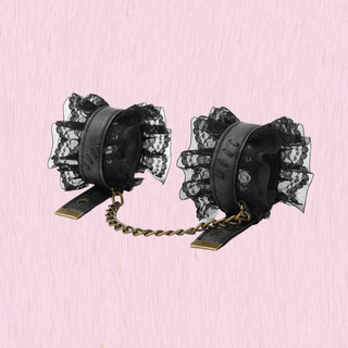 The wrist cuffs with non-detachable chains and lace edging
