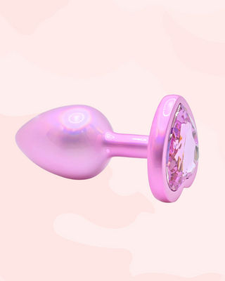 A close up of an individual pearl butt plug, you can see the metallic shine to the colouring and reflective jewelled end.