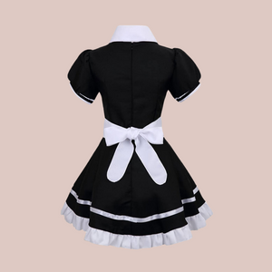 The back of The Size maids dress in black, you can see the white frilled edge to the skirt, the white collar and the tie bow half apron.