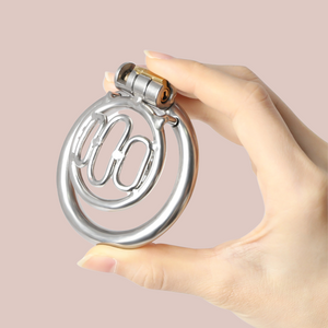 The Thrall chastity cage is shown here being held in an adult hand to give an idea of size, it shown with a 50mm base ring.
