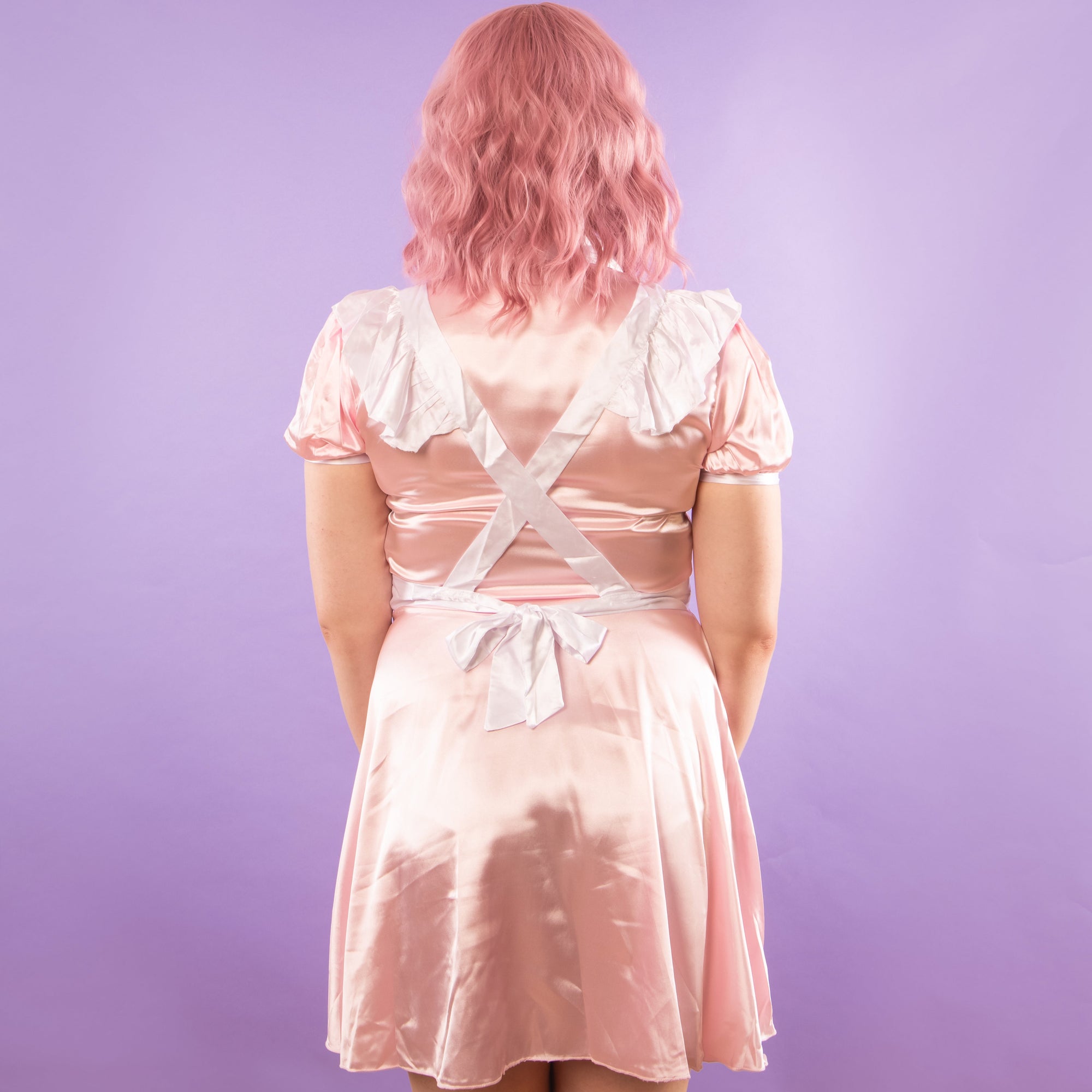 The rear view of The Belinda in pink, the skirt falls softly to the thigh.