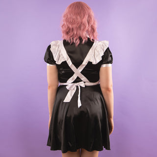 A rear view of The Belinda Maid Dress, the apron falls over the shoulders and ties at the waist.