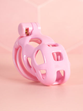 The Cobra Double Cuff cock cage in pink, this is a Nano sized cage and is shown fully assembled.