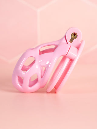 A side view of the Cobra Double Cuff, this pink cage is shown fully assembled in pink.