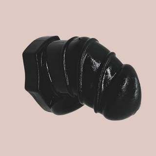 A side view of the  Detained Silicone from House Of Chastity, you can see the design to the body and that it comes in black 