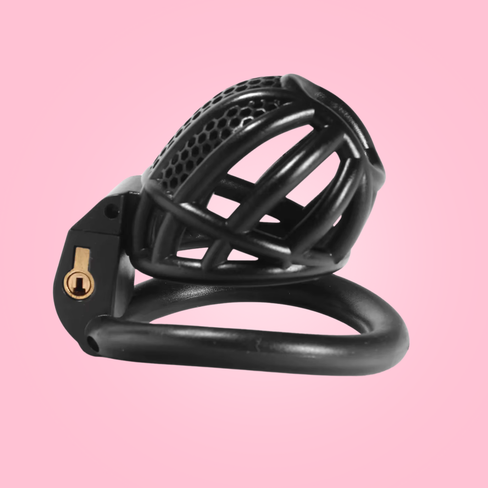 A side view of The Detained Small in black, the chastity cage is sitting on the base ring with the cage rising towards the sky
