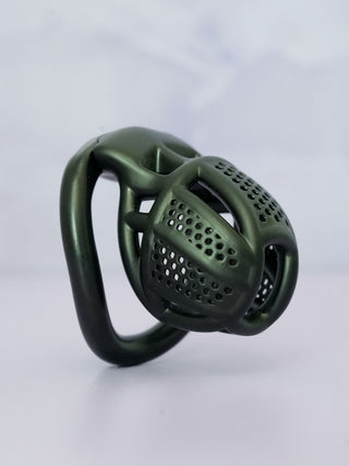 A side profile of the Detained chastity cage in black, the cut out design is showcased.