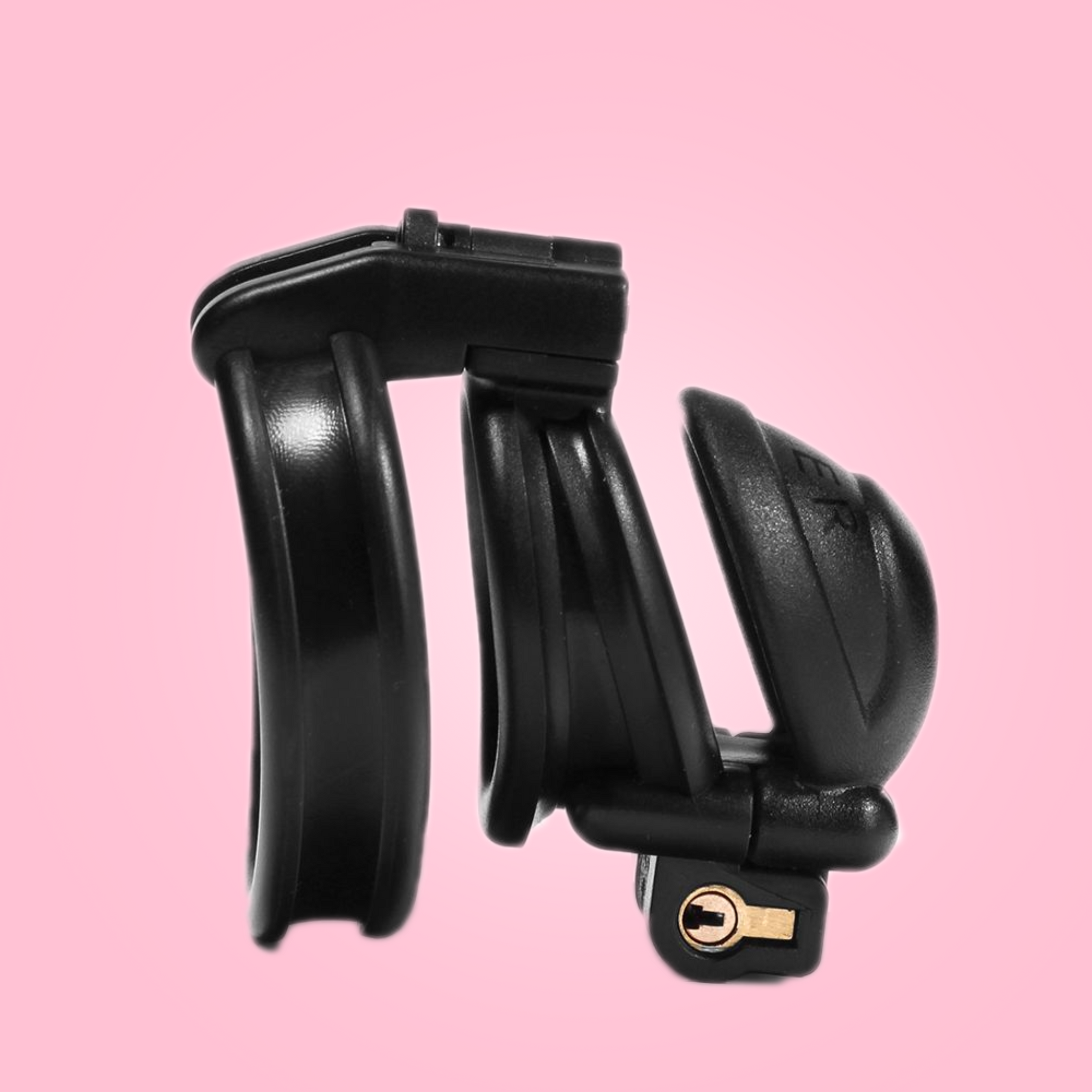 Showing the nub design of the slaver, that comes in 3 different sizes: nub, small and standard double lock cock cages. Made from black resin, with Slaver imprinted on the head.