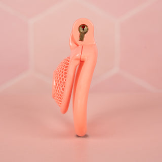 A side view of the The Snare Chastity Cage, you can see the integral lock fixed in place and the side profile shows just how small this cage is.