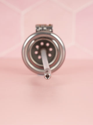 A rear view of the Ultra chastity cage, the circular air holes can just bee seen, as can the urethral tube.