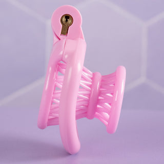 A side view of the pink chastity cage fully assembled.
