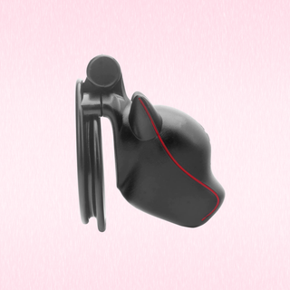 A side view of the Wolf Guard Chastity Cage, it is shown on a pink background.