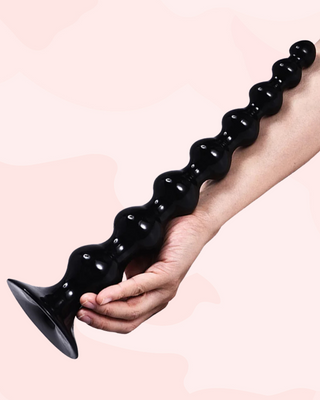 The Titan Anal Beads shown against an arm to show the super size, this is the size large.