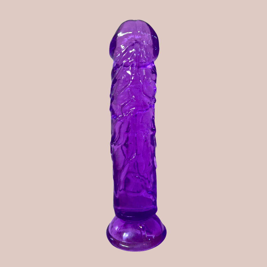The Purple Translucent Jelly Dildo shown sat on its suction cup base.