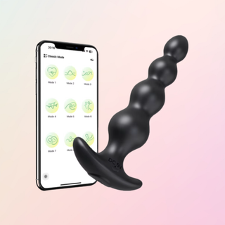 The vibrating butt plug is shown with a mobile phone  to show that it offers app control.