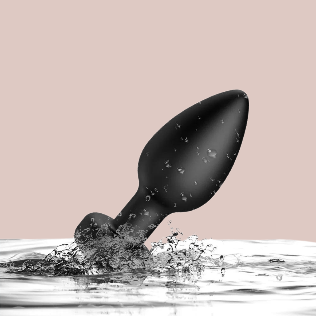 The black remote control anal plug is shown in water, as it is waterproof.