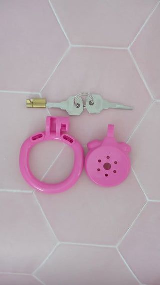 The Flat Gatling Chastity Cage in pink being assembled