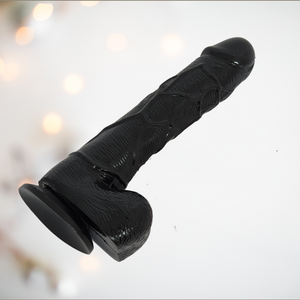 The Black 7 Inch Dildo from House of Chastity, you can see the realistic head, veining and balls, as well as the sucker base.