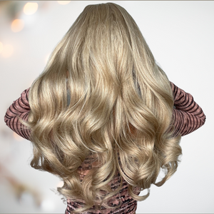 A blonde ombre long-length wig with a gorgeous soft curl running through it. Modelled for House of Chastity it has a very natural flowing look. View is from the back and shows its voluminous look.