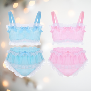 In baby blue or baby pink, this bra and panties set has bandeau style bra top edged in white lace and colour matching satin bows. The panties are a high waisted design and have matching lace frills and satin bows.