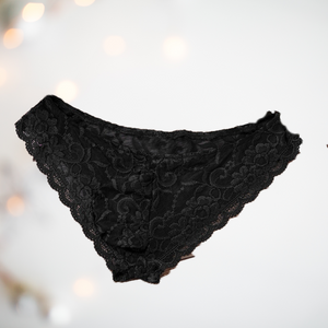 Floral lace panties from House Of Chastity. The knickers are black, and are in a bikini style with penis pouch. 