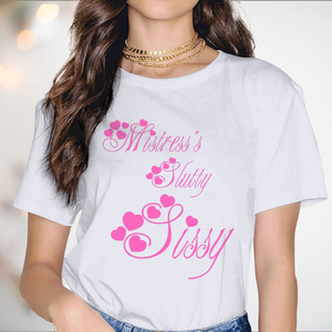 The Mistress's Slutty Sissy t-shirt from House Of Chastity, you can see the white round neck t-shirt with short sleeves, the printed pink writing and heart motifs.